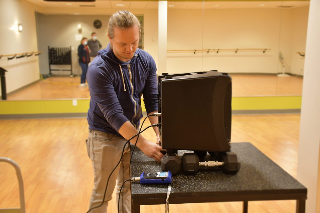 Drake Hintz Site Visit Acoustical designer, Drake Hintz, sets up equipment to test a corporate office space.